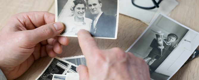 An elderly man looks through his old photographs of 1960-1965